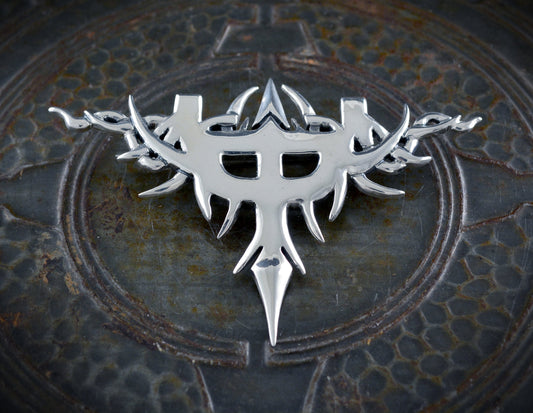 Silver brooch inspired by the emblem of Judas Priest